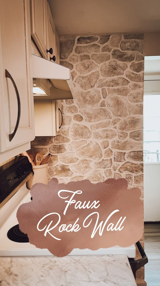 a kitchen with a stone wall and white cabinets in the background that says faux rock wall