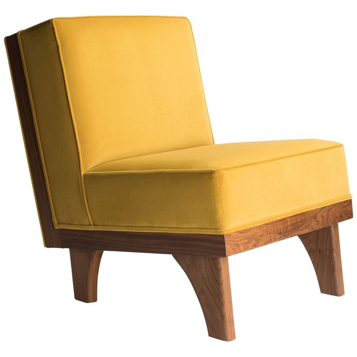 an upholstered yellow chair with wooden legs and arm rests on a white background