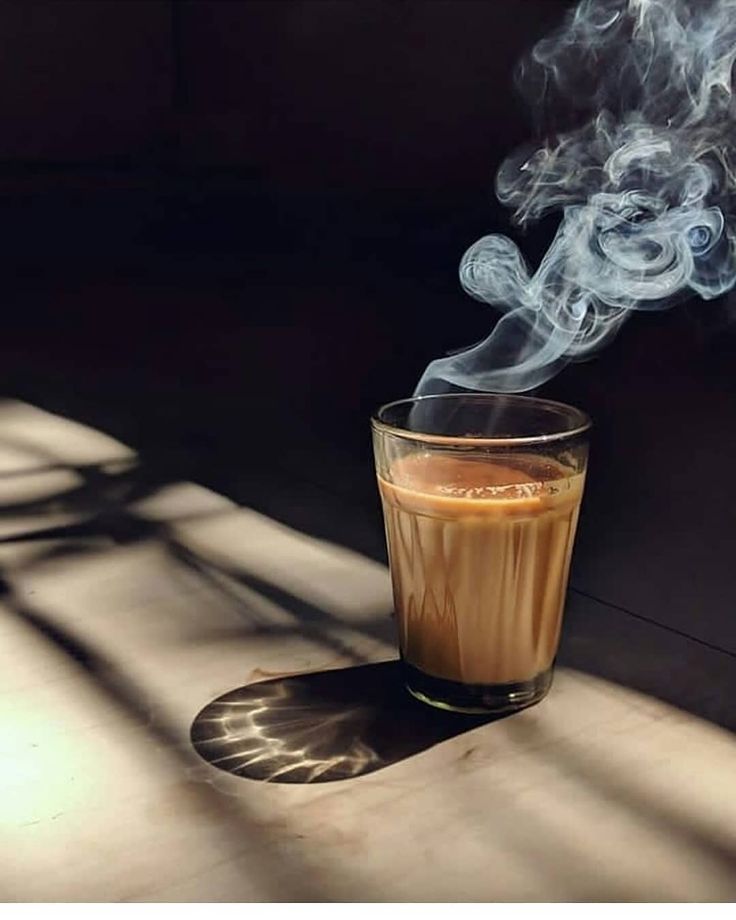 a glass filled with liquid sitting on top of a table