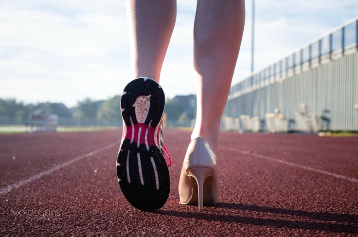 a woman's feet in high heels on a running track