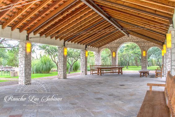 an outdoor covered area with benches and tables