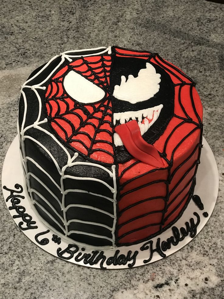 a spiderman birthday cake is decorated with black and red icing