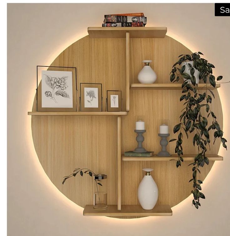 a round wooden shelf with vases and pictures on it