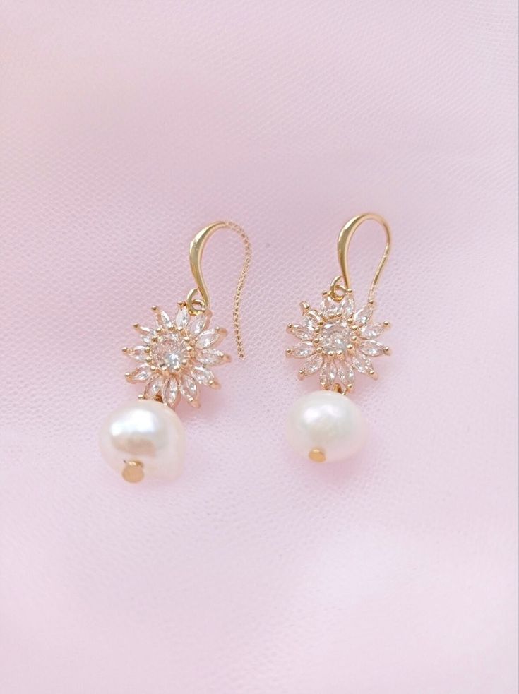 An elegant pair of cubic zirconia and pearl wedding earrings , adorned with freshwater pearls. Perfect jewelry to complete your wedding day look or to gift to bridesmaids White Bridal Earrings With Pearl Charm And Cubic Zirconia, Silver Gold Plated Bridal Earrings With Pearl Drop, Gold Plated Pearl Drop Bridal Earrings, Pearl White Bridal Earrings With Pearl Drop, Gold-plated Pearl Pendant Earrings For Wedding, Elegant Pearl Embellished Cubic Zirconia Earrings, Gold Plated Pearl Pendant Earrings For Wedding, Exquisite Pearl Drop Jewelry With Cubic Zirconia, Exquisite Akoya Pearl Earrings For Wedding