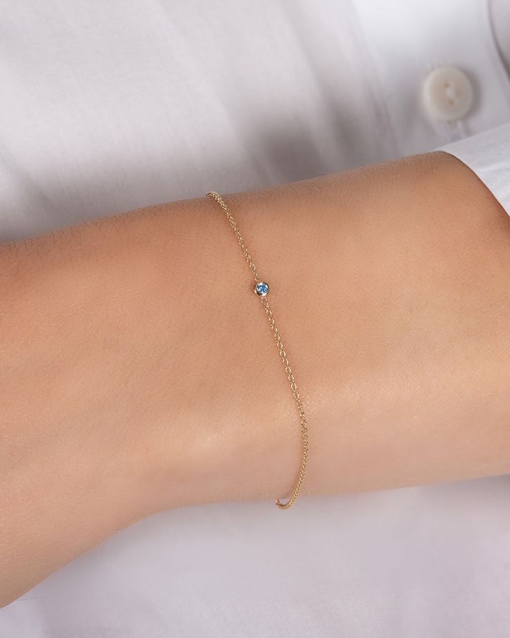 Beautifully handcrafted birthstone of your choice in a 14k yellow gold small mini bezel cup laying on a dainty cable link chain bracelet. Uber chic and timeless bracelet, perfect by itself or stacked. Total Weight: Approx. 0.7 grams Size of Mini Bezel Birthstone: Approx. 3mm Birthstone Bezel Carat Weight: Approx. 0.03 ctw Available Birthstones: Garnet, Amethyst, Aquamarine, Diamond, Emerald, Alexandrite, Ruby, Peridot, Sapphire, Rose Zircon, Topaz, Blue Zircon Standard Production: 5-8 business d Aquamarine Gold Bracelet, Single Stone Bracelet, Dainty 14k Gold Birthstone Chain Bracelet, Dainty Yellow Gold Chain Bracelet With Birthstone, Dainty 14k Gold Gemstone Chain Bracelet, 14k Gold Chain Bracelet With Bezel Setting As Gift, 14k Gold Chain Bracelet With Bezel Setting, Dainty Chain Bracelet With Bezel Setting As Gift, Timeless Bracelet