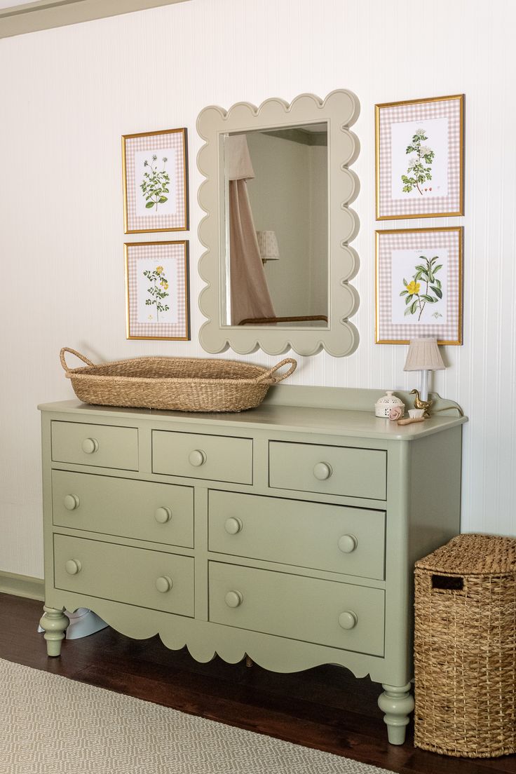 a dresser with a basket on top of it next to a mirror and other items