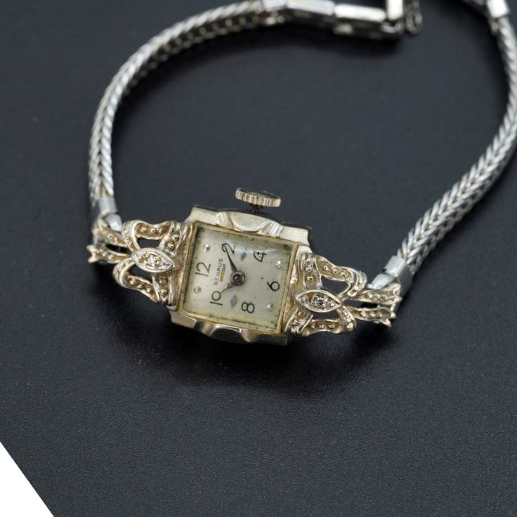 Vintage antique Benrus ladies watch 14k white gold case.  Watch is in working condition. Wind up watch. Fold over clasp with saftey chain. Weighs approx. 14.60 grams This is genuine 14k gold case and 10k gold filled strap. Watch is approx. 15mm in width. There are two diamonds on the case as well. ⭐️⭐️⭐️  MAIN SHOP PAGE ⭐️⭐️⭐️ www.etsy.com/shop/ronnie7 ⭐️⭐️⭐️  ABOUT PAGE ⭐️⭐️⭐️ www.etsy.com/shop/ronnie7/about ⭐️⭐️⭐️  PENDANT SECTION ⭐️⭐️⭐️ www.etsy.com/shop/Ronnie7?section_id=11397068 ⭐️⭐️⭐️ VIN Vintage 14k Stamped Jewelry For Formal Occasions, Antique Yellow Gold Watch For Evening, Antique Yellow Gold Watches For Evening, Antique Yellow Gold Evening Watch, Timeless Yellow Gold Wedding Jewelry And Watches, Timeless Yellow Gold Jewelry For Wedding, Antique 14k Gold Watches For Formal Occasions, Yellow Gold Art Deco Evening Watches, Art Deco Yellow Gold Evening Watches