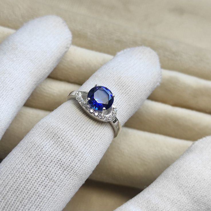 💍 Amazing! Blue Sapphire Ring 💍 Metal: 925 Sterling Silver. Stones: Lab Sapphire Ring Size: Can be selected Total Weight: 2.6 grams Stone Shape: Round Stone Size: 8 mm Stone Weight: 2 carats Lab-created stone Anti-tarnishing coated This stunning ring is crafted with good-quality sapphire lab-created stone with 925 sterling silver. The blue gemstones create a beautiful contrast against the polished silver ring. The ring is perfect for stacking with other rings and can be worn as a standalone pi Diamond White Sapphire Ring With Center Stone For Gift, White Sapphire Ring With Center Stone As Gift, Sapphire Open Ring Jewelry For Anniversary, Diamond White Sapphire Rings With Gemstones, Classic Round Crystal Birthstone Ring, Classic White Gold Crystal Ring With Birthstone, Lab-created Sapphire Gemstone Promise Ring, Promise Ring With Lab-created Sapphire Gemstone, Silver Sapphire Crystal Ring As A Gift