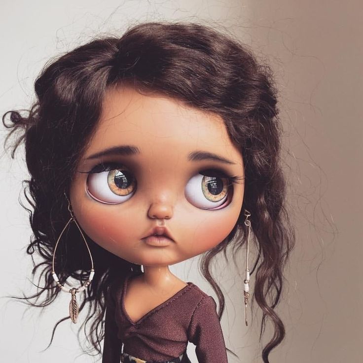 a close up of a doll with big eyes