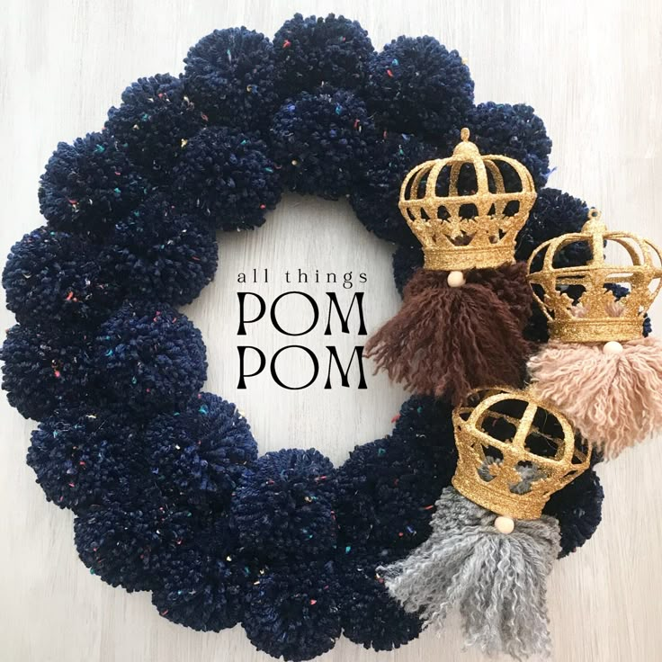 a wreath with some tassels on it and the words pom pom