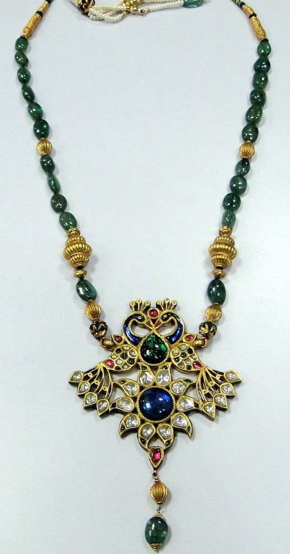 Vintage Antique 22 ct gold Peacock necklace kundan meena polki diamond necklace A genuine antique rare piece of jewel comes from the houses of Mewar,made with high calibre kundan polkee (old uncut diamonds) and genuine natural gemstones necklace (Kundan Meena choker). A beautiful peacock set with genuine gemstone absolute breathtaking piece in very good condition strung with emerald and gold beads fully handmade one of a type with very elobrate enamel work at the back. Could be worn either side. 22k Gold Kundan Pendant Necklace For Diwali, Antique 22k Gold Chandbali Jewelry, Antique 22k Gold Meenakari Jewelry, Ornate Kundan Yellow Gold Necklaces, Ornate Jeweled Pendant Jewelry, Kundan Jewelry With Peacock Design, Wedding Kundan Peacock Pendant Necklace, Wedding Kundan Necklace Pendant With Peacock Design, Ornate Meenakari Pendant Jewelry