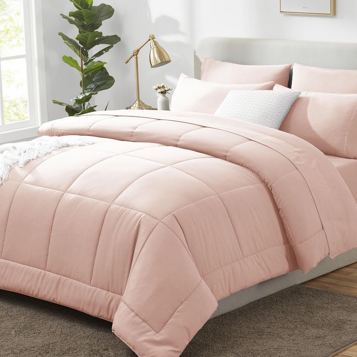 PRICES MAY VARY. PERFECT FOR ALL SEASONS: Queen comforter set made with premium microfiber filling and a quilted design for extra softness, volume, and durability—the queen comforter set offers just the right amount of warmth for all season comfort. ELABORATE DESIGN: This queen bedding set includes a fitted sheet with a pocket for mattresses up to 14" deep, envelope closure pillowcases to keep your pillows secure, and the comforter features durable box stitching which offers sophisticated look a Pale Pink Comforter, Plain Pink Bedding, Rose Gold Comforter Set, Pink Comforter Set, Light Pink Bed Set, Pink Gold And White Bedroom, Pink Bedding Aesthetic, Rose Gold Bedding, Full Size Bed Comforter