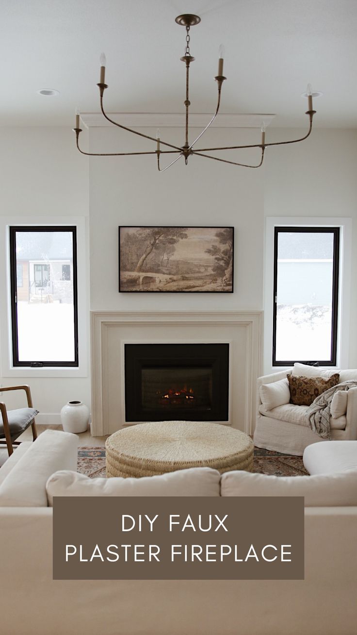 a living room filled with furniture and a fire place under a chandelier over a fireplace