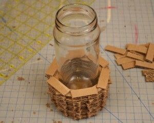 a mason jar filled with lots of cardboard pieces