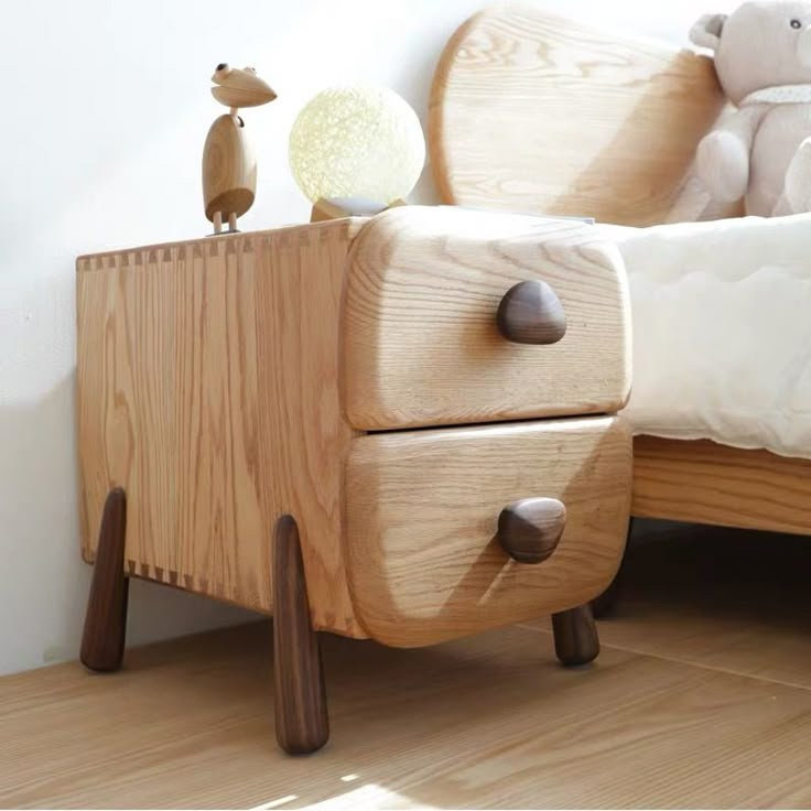 a wooden bed with two teddy bears sitting on top of it