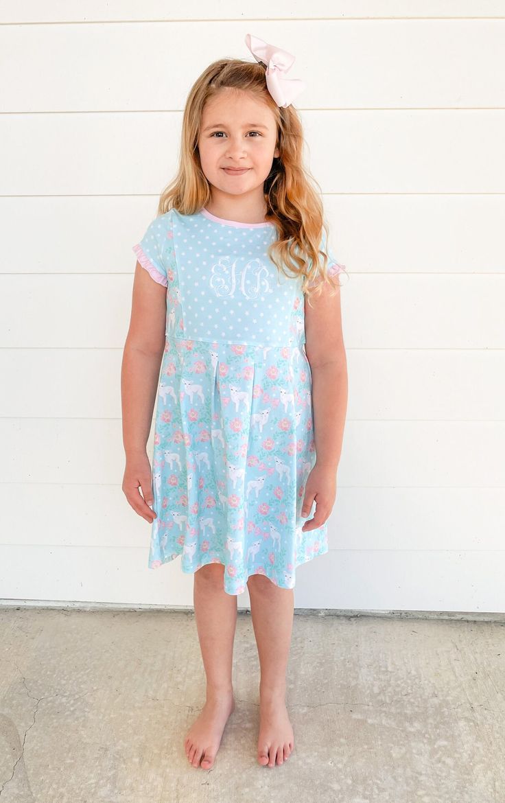 "\"He saw Jesus passing by, and said, \"Look! This is the Lamb of God!\" John 1:36 FBV This short sleeve dress is sure to be a spring favorite. Sweet ruffles at the sleeves and delicate pink trim with pink buttons on the back. This style is also great for monograming. What better way to discuss John 1:36 and Jesus than with a lamb print. Easter is a wonderful time to talk about the Lamb of God, Christ, with your child. She will love looking at the sweet lamb on this dress. We placed God's word i Summer Short Sleeve Dress For Sleepover, Casual Short Sleeve Dress With Flutter Sleeves For Spring, Summer Sleepover Dress With Short Sleeves, Playful Ruffled Short Sleeve Dress, Playful Short Sleeve Dress With Ruffles, Cute Spring Dress For Sleepover, Cute Spring Sleepover Dress, Pink Dress For Sleepover In Spring, Cotton Short Sleeve Dress For Sleepover