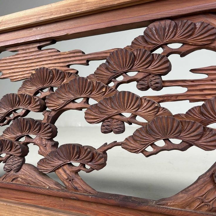 an intricately carved wooden frame with flowers and leaves