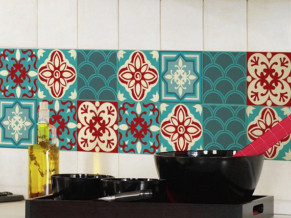 a stove top oven sitting next to a wall covered in colorful tiled tiles and cooking utensils