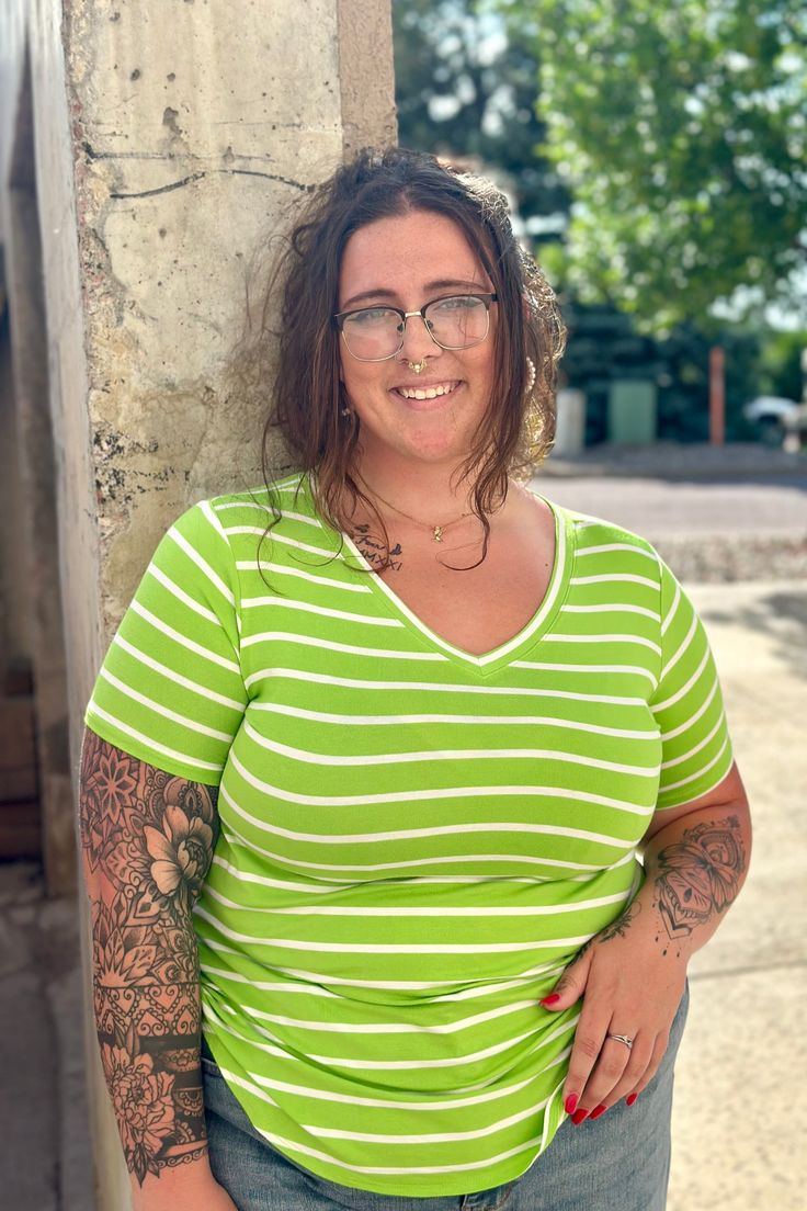 Check out this show-stopping bright lime striped top! Add a serious pop of WOW to your wardrobe with this "Amanda" short-sleeved top. Features a rounded hem, V-neckline and an almost tunic length. Lime Green color with Ivory stripes 95% Rayon / 5% Spandex Measured from a Small: Body Length - 27" / Bust - 35" Measured from a 1X: Body Length - 28.5" / Bust - 43" TTS Fit. Striped Short, Tunic Length, Women Clothes, Striped Shorts, Short Sleeve Top, Lime Green, Green Colors, Green Color, Short Sleeves Tops