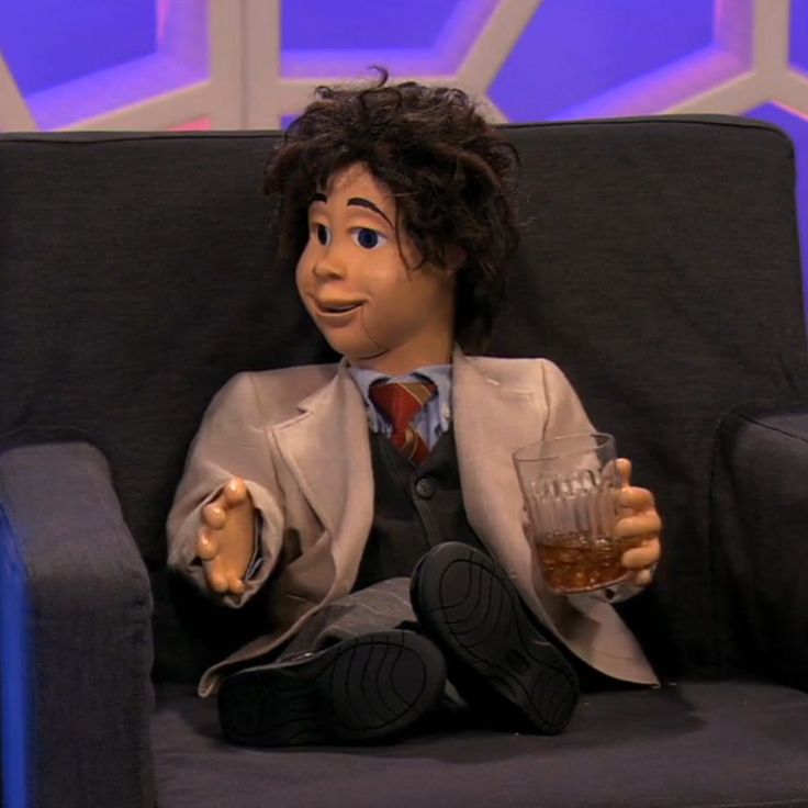 the puppet is holding a glass in his hand