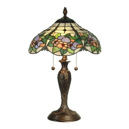 a lamp that is sitting on top of a table with a flower design on it