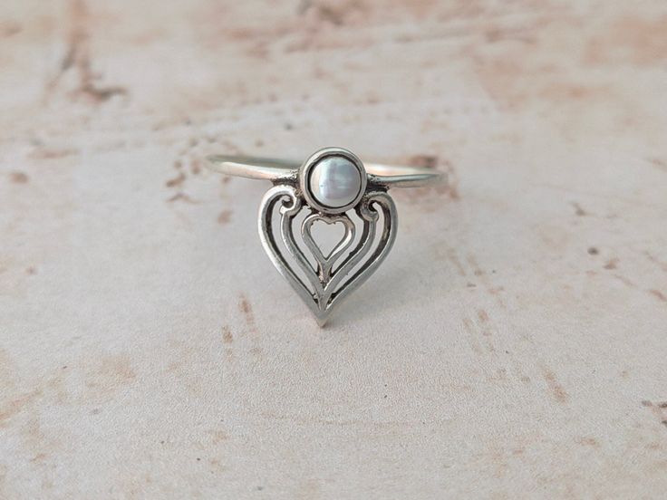 This is a listing of Round Pearl sterling silver Stacking ring , this is very unique ring for stacking .. This is a listing of Boho sterling silver ring # metal = sterling silver 925 # Title - Round silver simple ring # Ring Size - Available in all Size # Band Color - silver Handmade Crafting bohemian Ring - This style has bohemian style . it will look beautiful when you wear it .. Thanks for visiting our shop ... favorite our shop for daily updates ... Adjustable Silver Pearl Promise Ring, Silver Stackable Open Pearl Ring, Silver Stackable Midi Rings For Promise, Handmade Silver Moonstone Ring For Wedding, Silver Sterling Silver Moonstone Ring As Gift, Delicate Silver Round Ring, Delicate Silver Moonstone Ring For Gift, Dainty Hand Forged Sterling Silver Stackable Rings, Adjustable Silver Dainty Pearl Ring