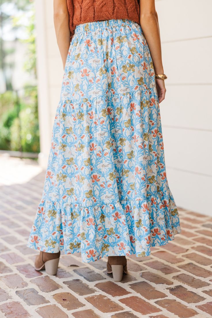 You are going to love when you get to start the day with this maxi skirt! That pattern is so pretty and we love the colors! This maxi skirt is perfect for the fall! Elastic waist Tiered Floral print No stretch Baileigh is wearing the small. Floral Long Skirt Light Blue, Blue Flowy Tiered Maxi Skirt, Bohemian Maxi Skirt With Elastic Waistband For Day Out, Blue Floral Print Tiered Maxi Skirt, Blue Tiered Maxi Dress For Vacation, Blue Flowy Floral Print Bottoms, Spring Boho Print Tiered Maxi Skirt, Blue Lined Maxi Skirt For Day Out, Blue Maxi Skirt For Brunch