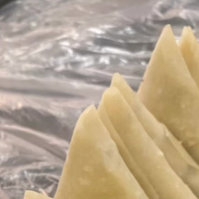 dumplings are being cooked in a pan on the stove with tin foil behind them