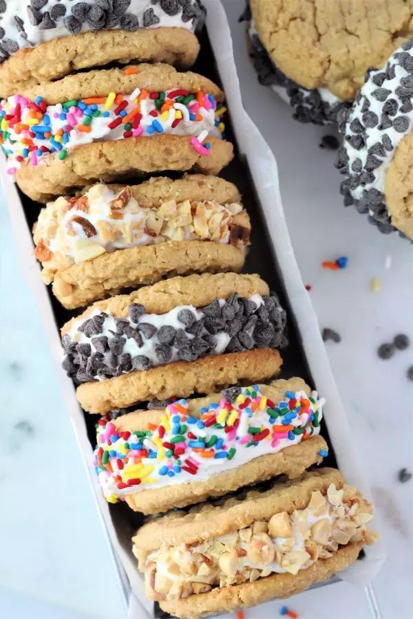 a box filled with cookies covered in frosting and sprinkles