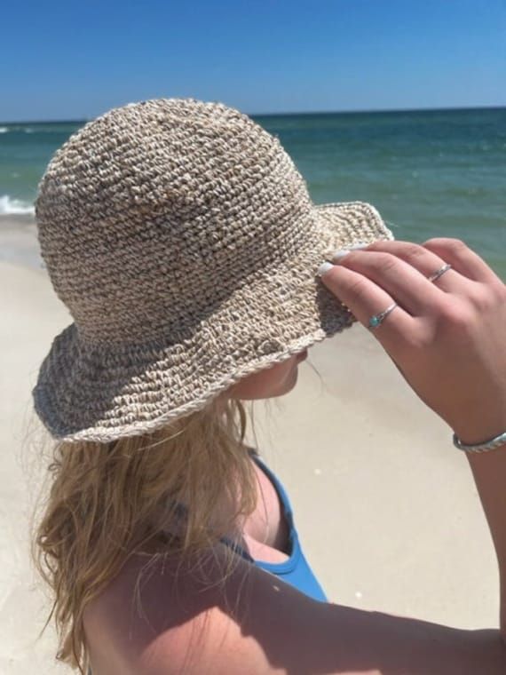 Organic Hemp Crochet Sun Hat  Our handmade crocheted sun hats are made from pure hemp yarn from Nepal. Perfect for summer...at the beach, pool, festival or just hanging around. They come in one size which fits most! As with many 100% hemp products they maybe slightly stiff, but soften and stretch over time. Features:  - 100% Hemp hat and handmade in Nepal  - It has wire in the rim means you can shape the hat however you desire and flat pack it for easy storage or travel.  - One size which fit mo Lightweight Beige Crochet Hat For Beach Season, Beige Lightweight Crochet Hat For Beach Season, Beige Crochet Bucket Hat For Beach Season, Beige Crochet Bucket Hat For Vacation, Beige Crochet Hat With Short Brim For Summer, Beige Wide Brim Crochet Hat For Outdoor, Beige Woven Hat For Warm Weather, Casual Cream Crochet Hat For Beach, Natural Lightweight Wide Brim Crochet Hat