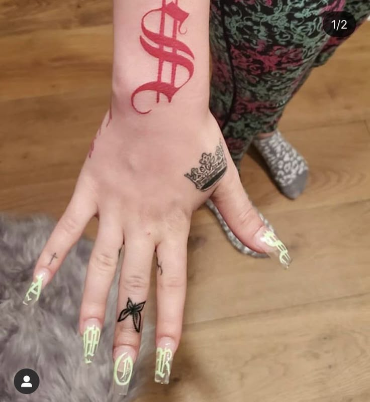 a woman's hand with tattoos on her left and right palm, which has the symbol of cadus painted on it