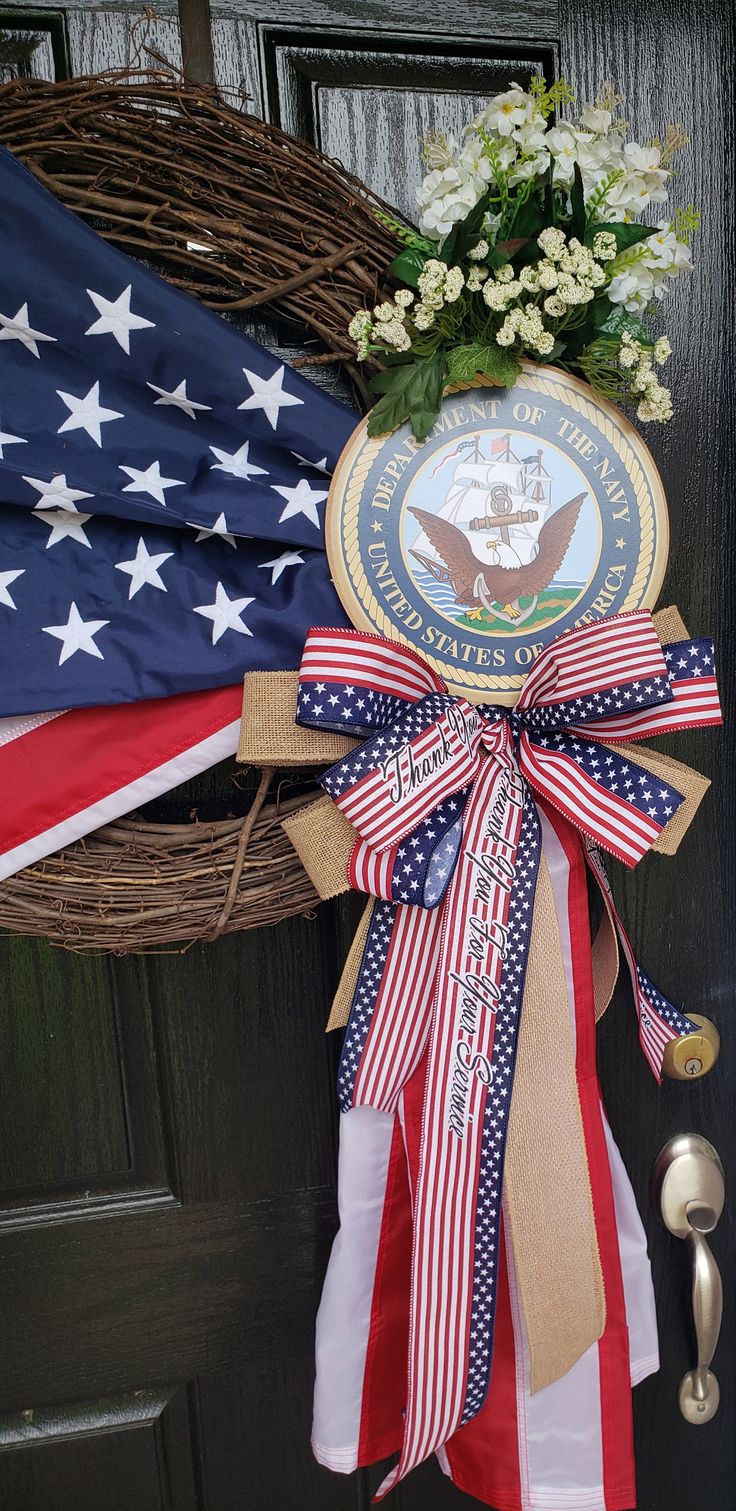 the door is decorated with an american flag and wreath