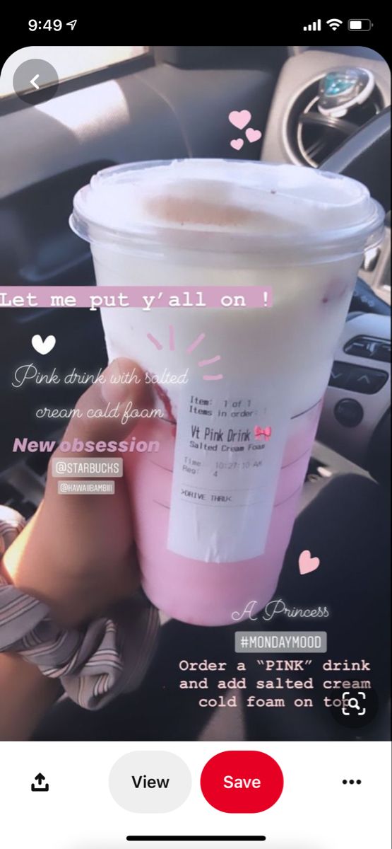 a pink drink sitting on top of a car dashboard