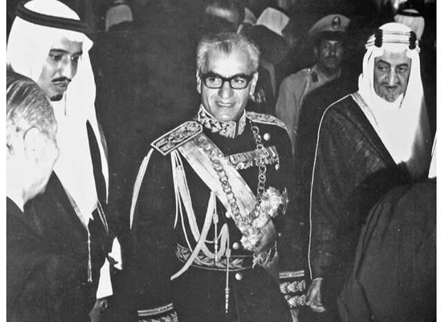 an old black and white photo of two men standing next to each other in front of people