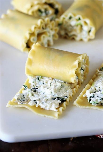 some ravioli with cheese and spinach on a white plate