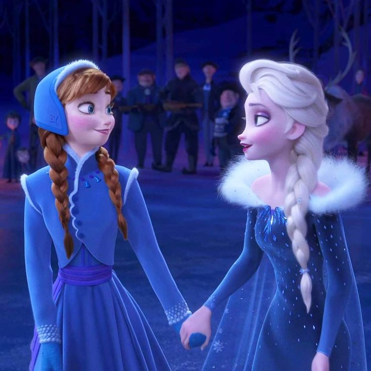 two frozen princesses holding hands in front of an audience