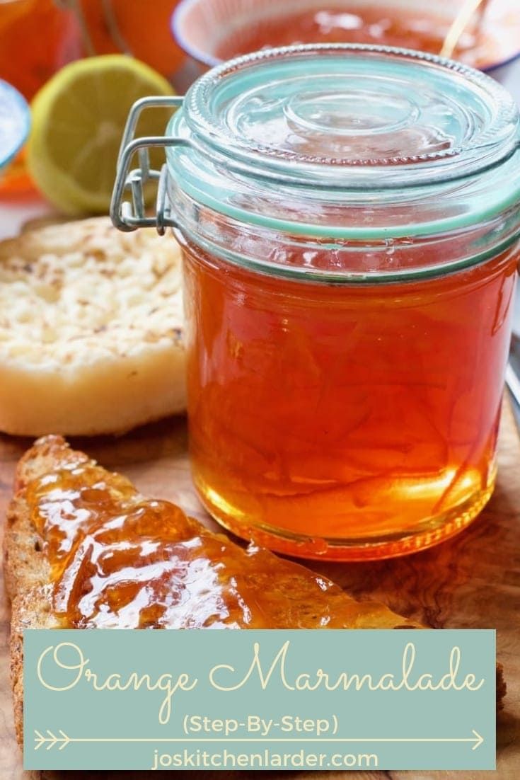 orange marmalade in a mason jar next to sliced bread