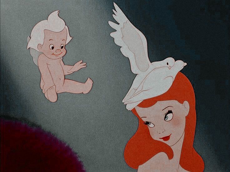 the little mermaid is looking at an angel flying over her head, and she has red hair