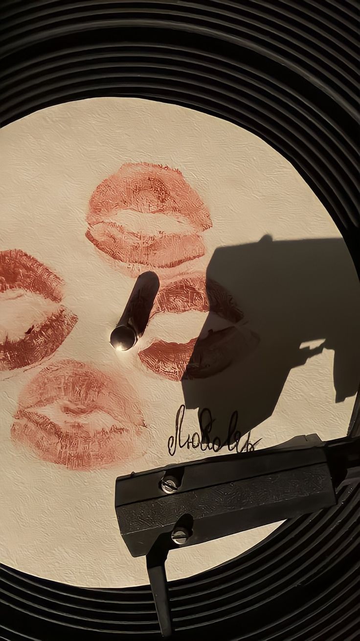 a close up of a plate with lipstick drawn on it