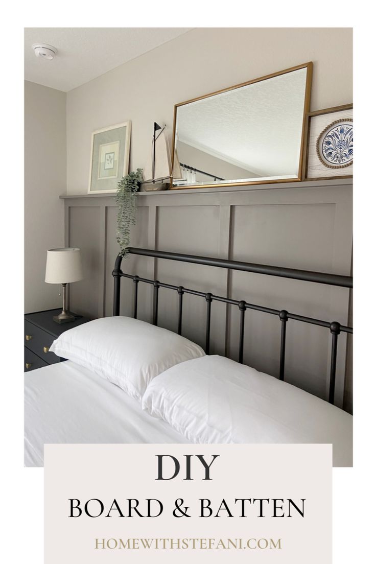 a bed with white sheets and pillows next to a mirror on top of the headboard