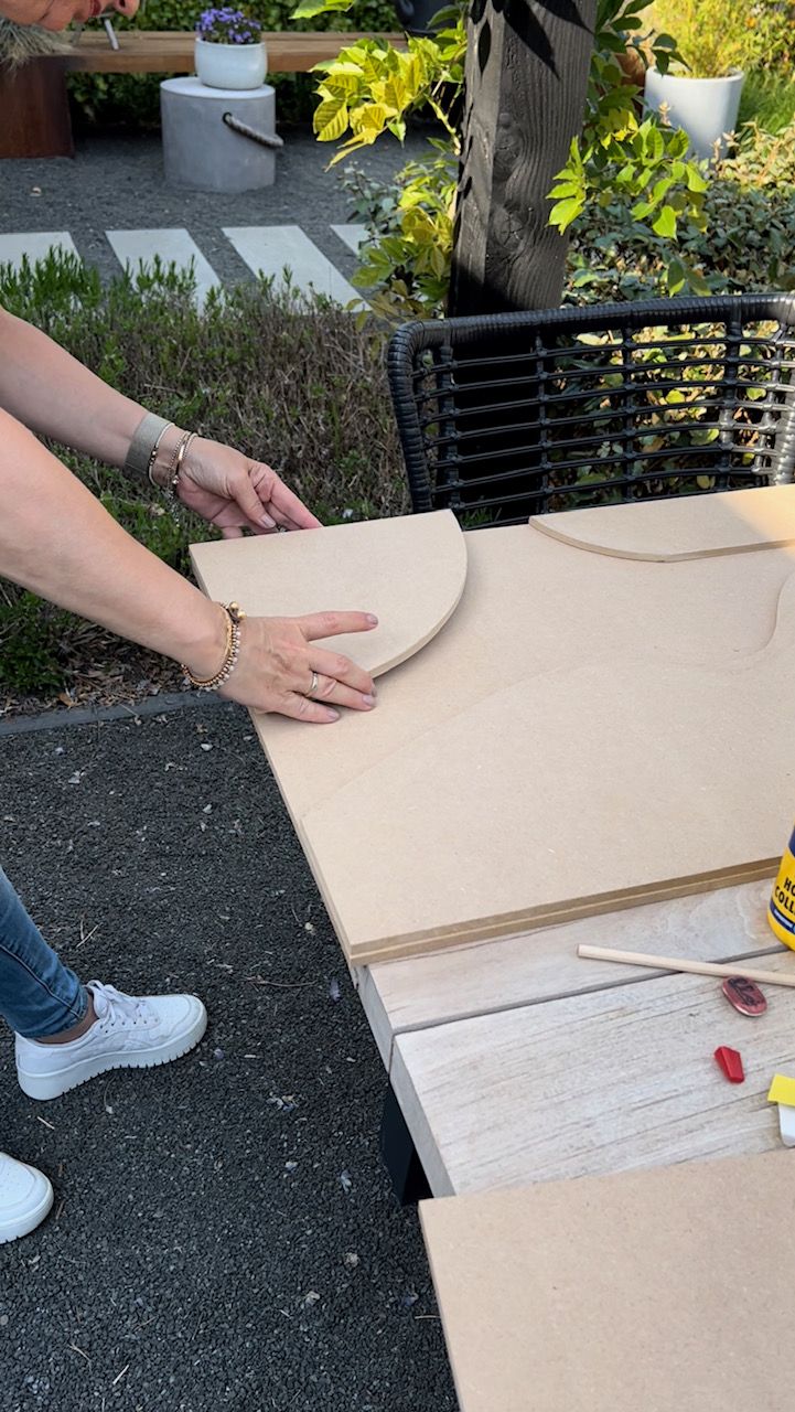 a woman is making a box out of cardboard and glues it with her hands