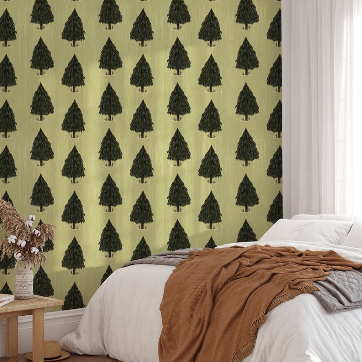 a bedroom with a green wallpaper and white bedding has a brown blanket on it