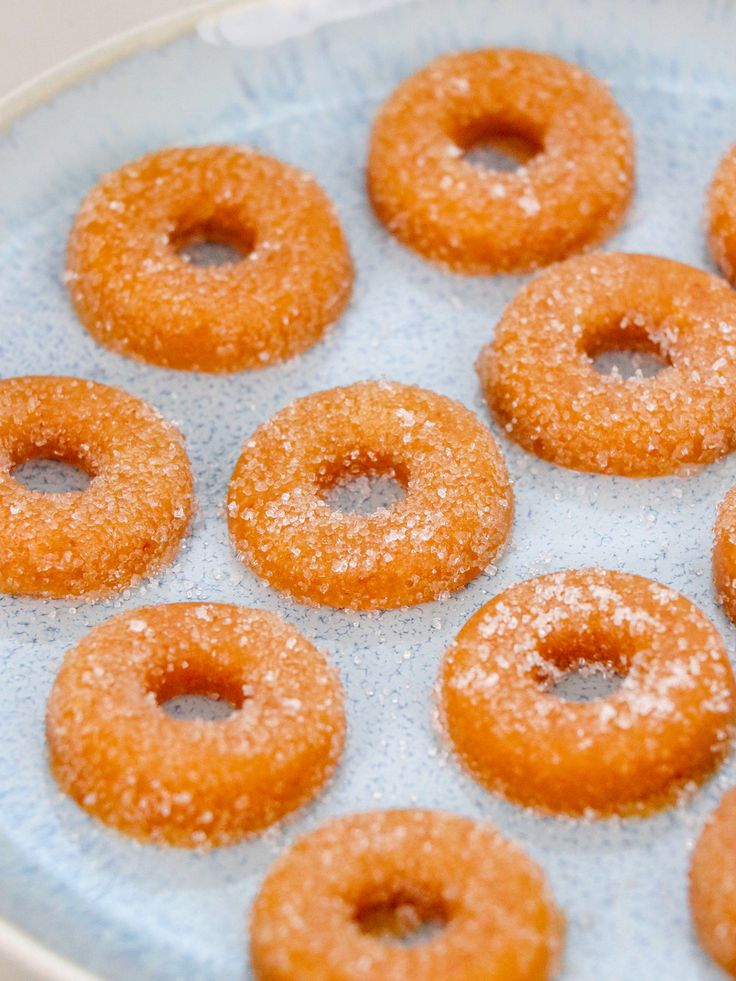 there are many donuts that are on the plate and ready to be eaten in the oven