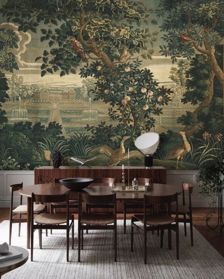 a dining room with a large wall mural behind it