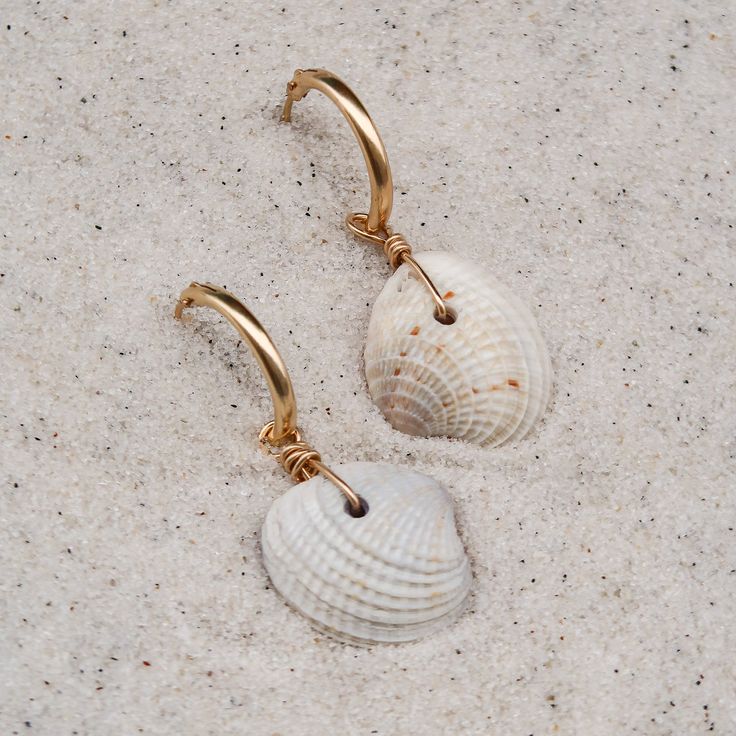 Easy, breezy, and a little bit beachy - the perfect earring when you want better than basics. ABOUT THE NAME Cortez Beach is one of the last remaining fishing villages on Florida's southwest Gulf coast. Just pull off the side of the road and take a quick walk through the tall trees and coastal grasses to the white sand beach. MATERIALS Cross-barred Venus shells on with 14k gold-filled hoops Every stone, shell, and handmade glass piece is unique, which means that each charm is too. You can expect Coastal Grasses, Beach Earrings, Gold Filled Hoops, Tall Trees, Earring Charms, Fishing Villages, Easy Breezy, Shell Earrings, White Sand Beach