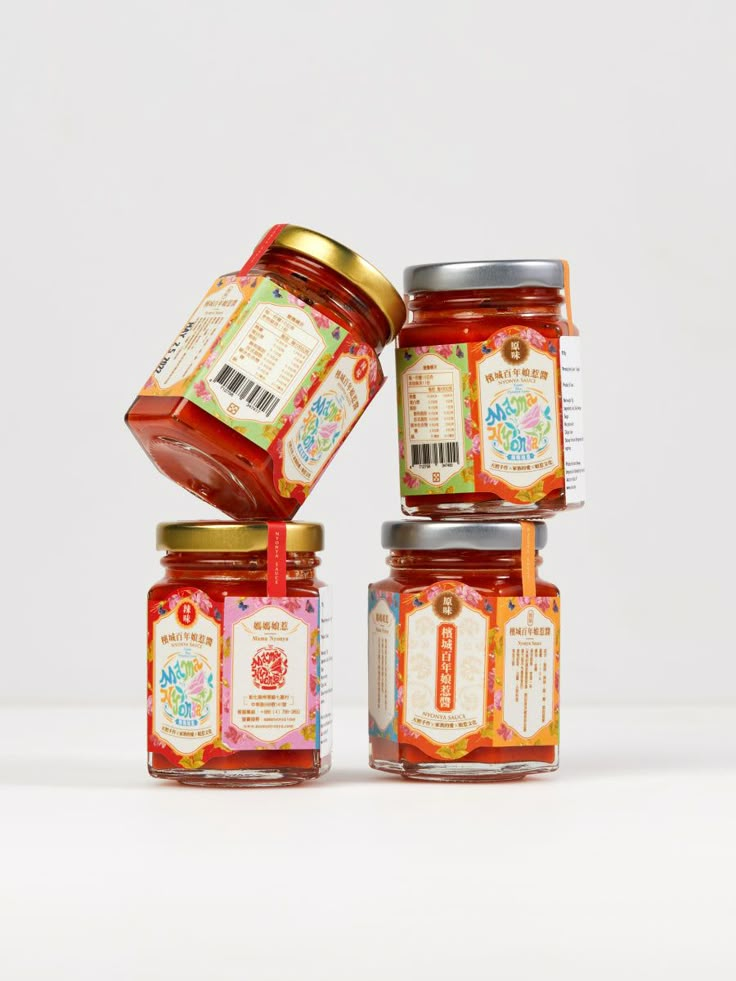 four jars of jam are stacked on top of each other