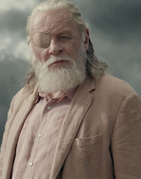 an old man with a long white beard standing in front of a dark cloud filled sky