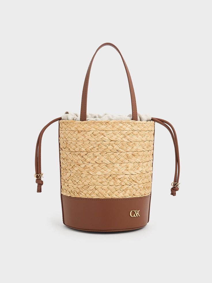 Luxury Leather Summer Bag, Luxury Leather Bags For Summer, Luxury Beige Bucket Bag With Intrecciato Weave, Luxury Spring Bucket Shoulder Bag, Chic Leather Bucket Bag For Spring, Chic Spring Leather Bucket Bag, Luxury Natural Straw Bag With Adjustable Strap, Luxury Bucket Tote Bag For Spring, Chic Beige Bucket Bag For Beach Season