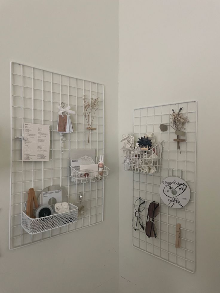 there are two white shelves on the wall with various items in them and one is hanging from it's side