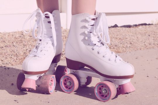 a close up of a person on roller skates with pink wheels and laces